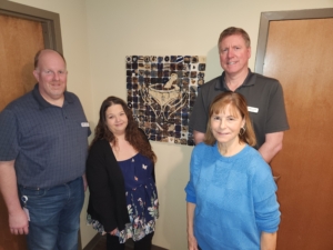 Pharmacy of Grace staff in front of the tile art project